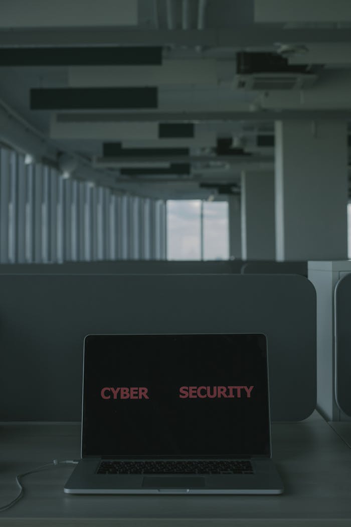 journey Laptop displaying 'Cyber Security' in a modern office setting, emphasizing tech and cybersecurity themes.
